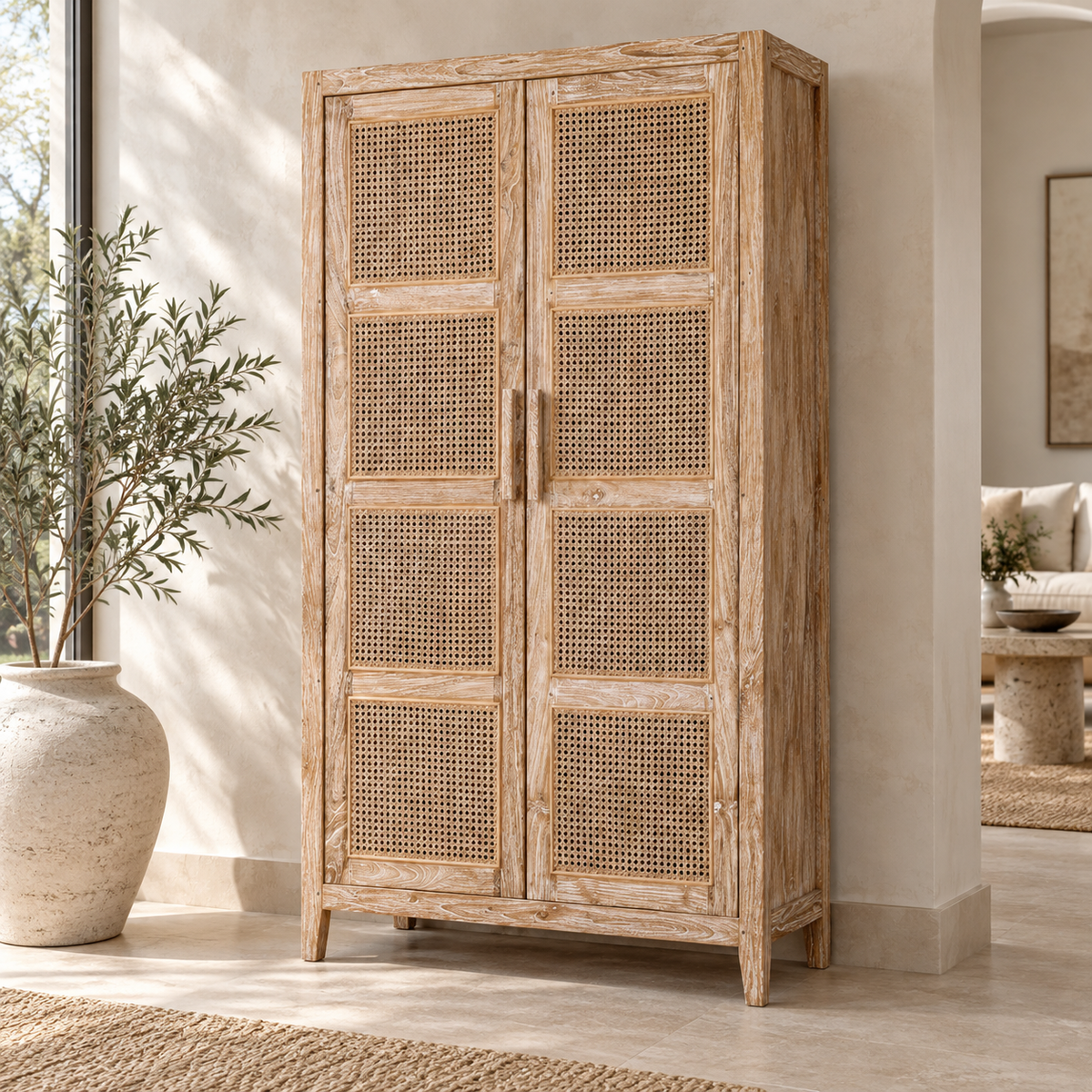 Oslo tall whitewashed teak cabinet with two handwoven rattan doors and tapered wooden legs.