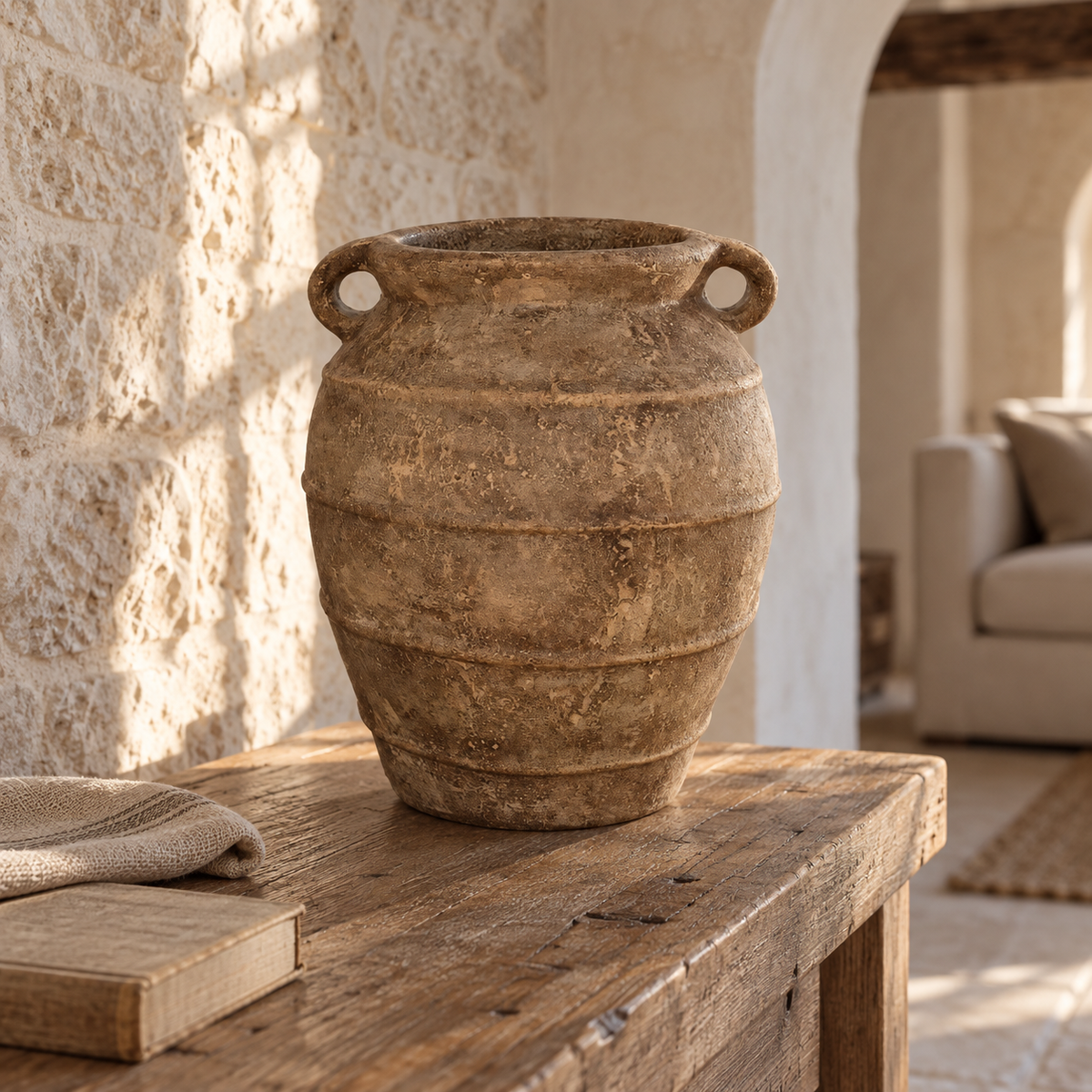 Zion antique-style clay vase with two handles on a reclaimed wood table in a rustic stone interior